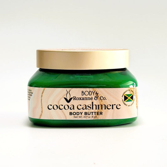 Green jar of Roxanne & Co. cocoa cashmere body butter on a white background