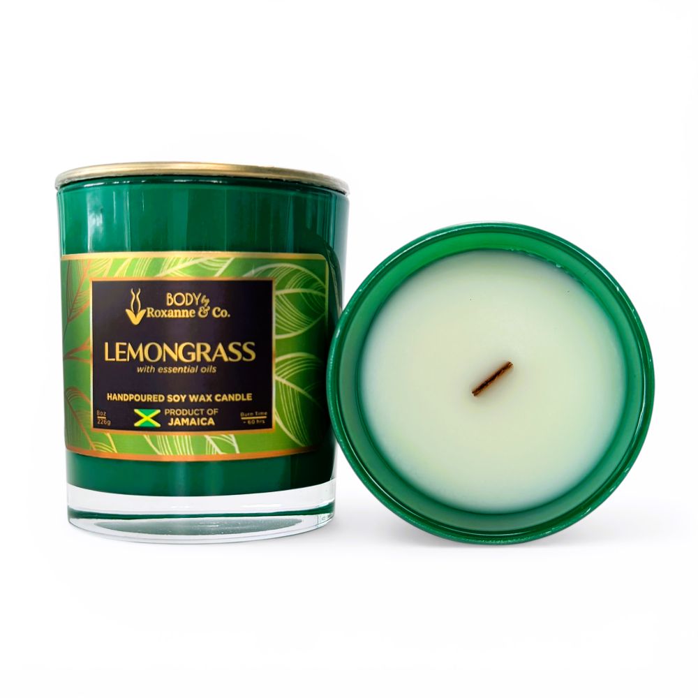 Green candle with a visible wick and open lid on a white background