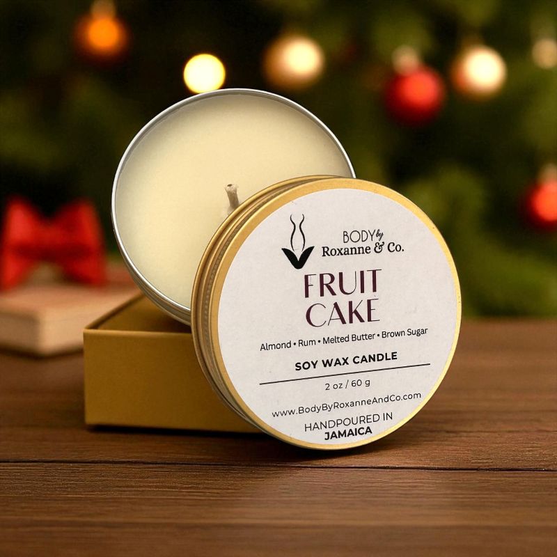 Soy wax candle in a tin with 'Body by Roxanne & Co.' branding, set against a festive background.