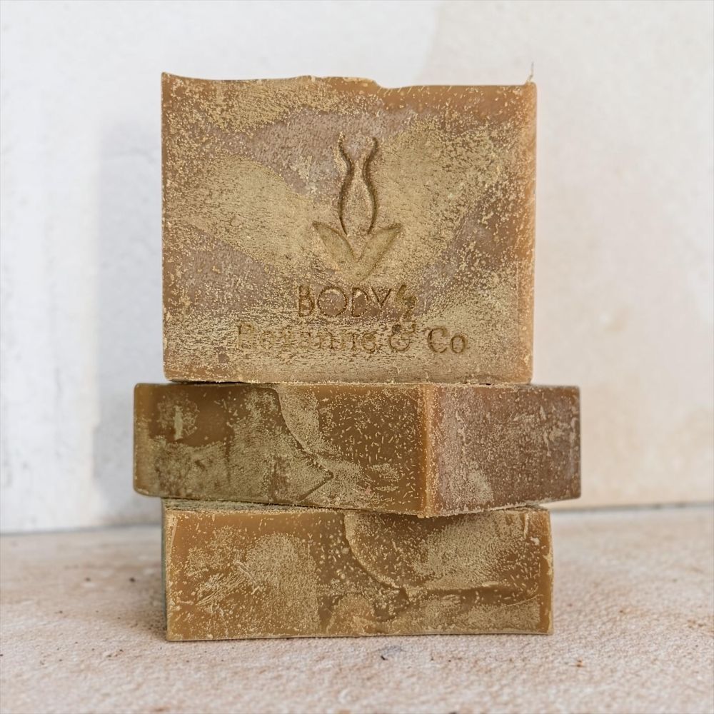 Three stacked rectangular bars of handmade soap in a warm brown and tan color, with the top bar embossed with a leaf logo and the text 'BONY's Handmade & Co'.