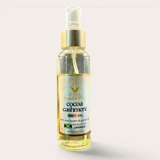 Bottle of cocoa cashmere body oil on a light gray background
