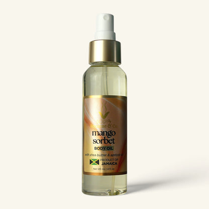 A clear plastic spray bottle of Mango Sorbet Body Oil with a white pump dispenser and a gold label, set against a solid off-white background.