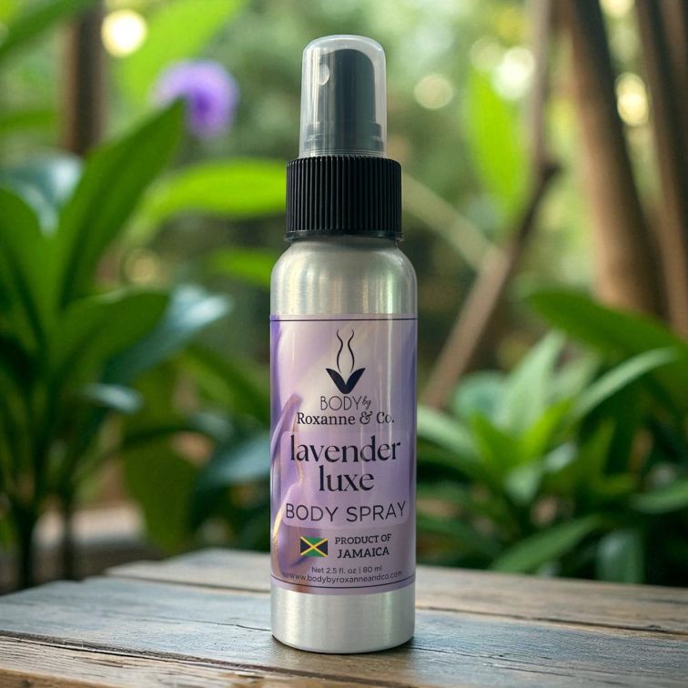 Lavender luxe body spray bottle on a wooden surface with green plants in the background