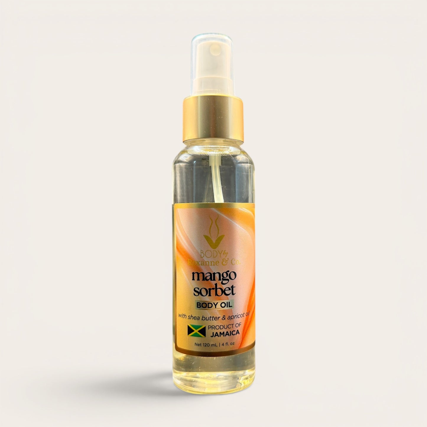 Bottle of mango sorbet body oil on a light gray background