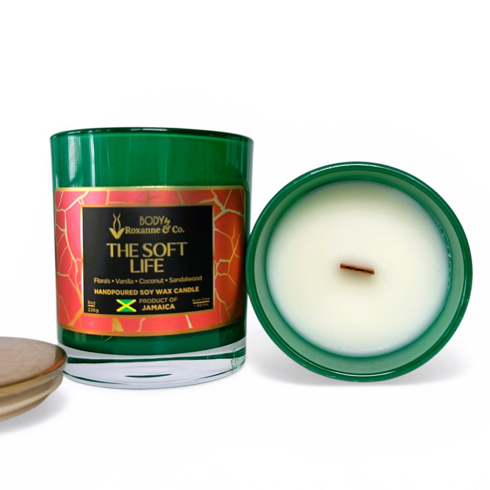 Candle with a green jar and decorative label on a white background