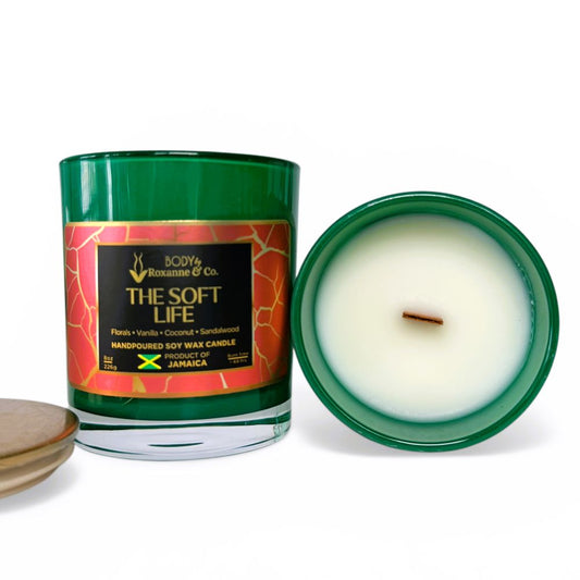 Candle with a green jar and decorative label on a white background