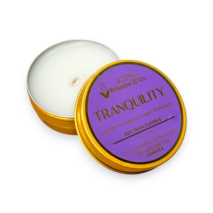 Soy wax candle in a tin with a purple label on a white background