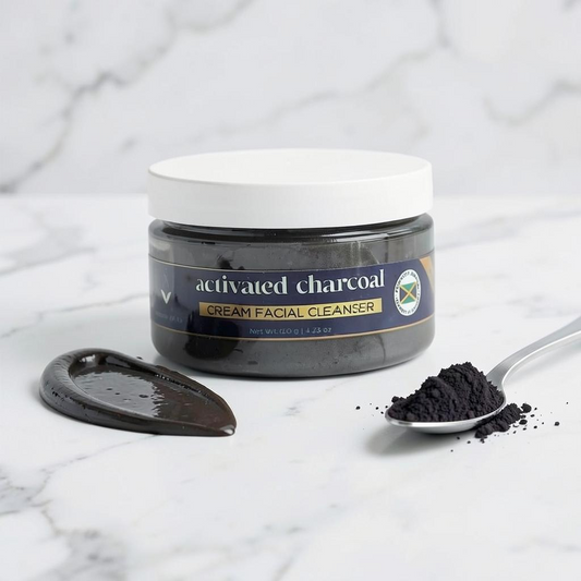 BODY By Roxanne & Co. activated charcoal cream facial cleanser in a jar with a spoonful of charcoal powder