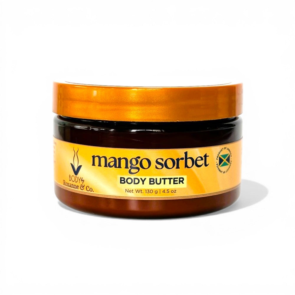 Jar of mango sorbet body butter with a gold lid on a white background